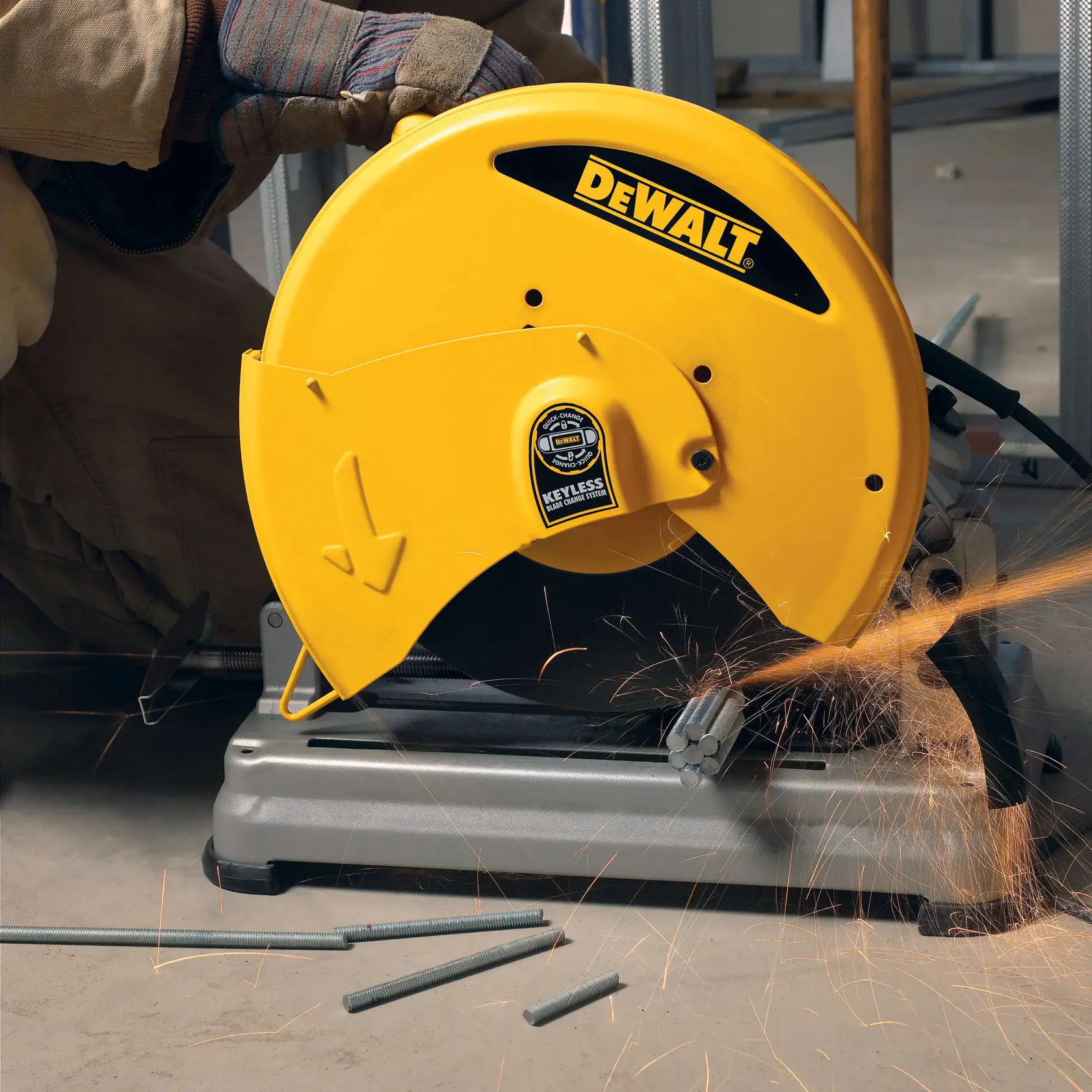 A DEWALT cutting machine in use, cutting metal rods and creating sparks. The machine is yellow with DEWALT branding and is operated by a gloved hand.